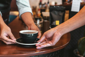 Handing over coffee at a cafe